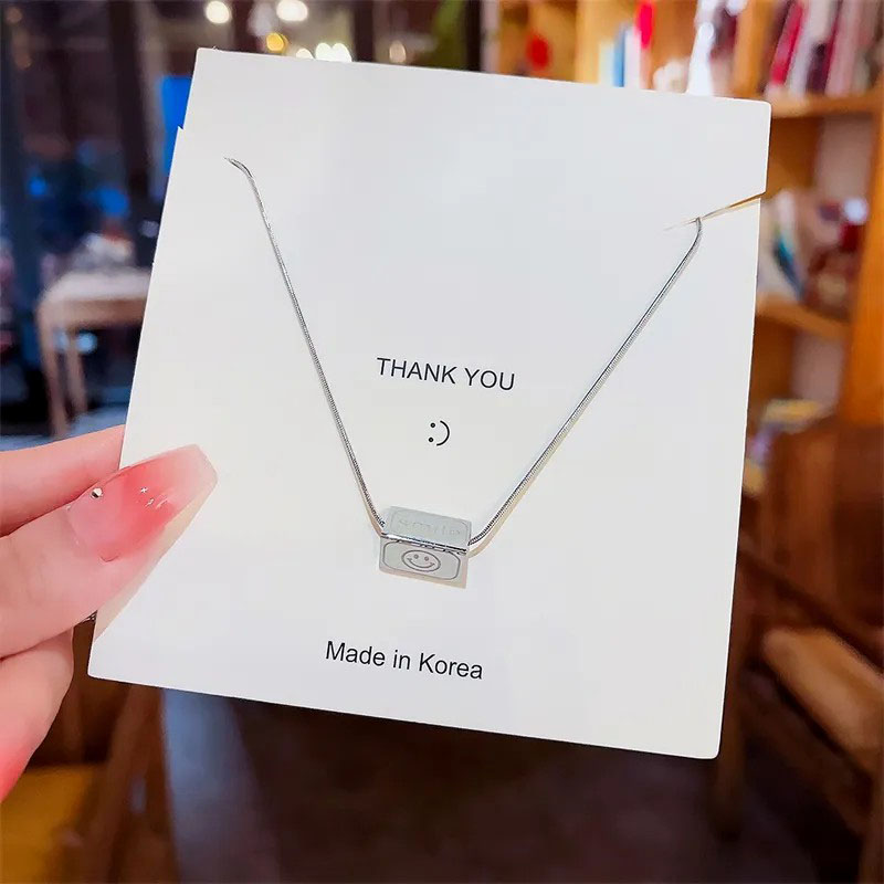geometric with smiley, steel necklace