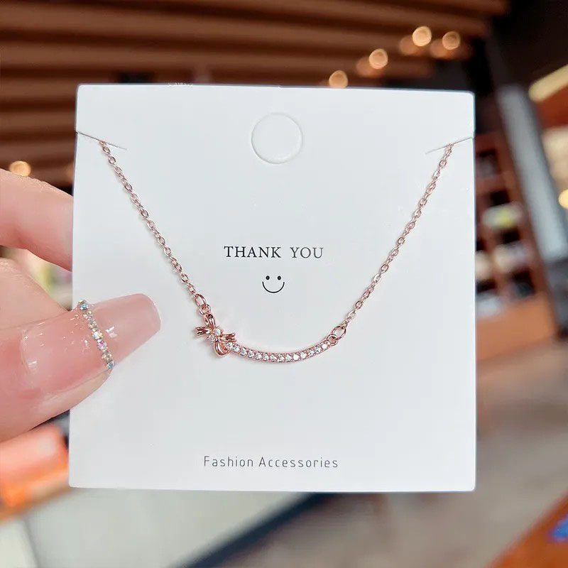 zircon inlaid, smiley with bowknot, stainless steel necklace