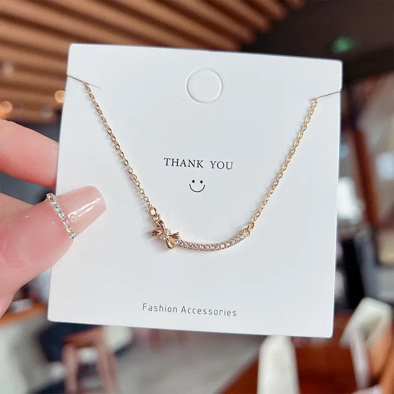 zircon inlaid, smiley with bowknot, stainless steel necklace